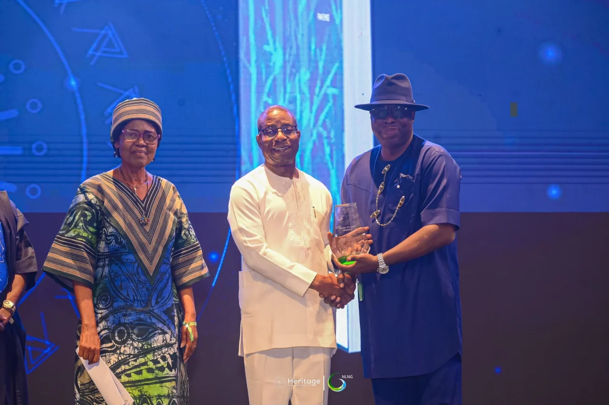 Ogaga Ifowodo receiving an award on stage alongside event officials