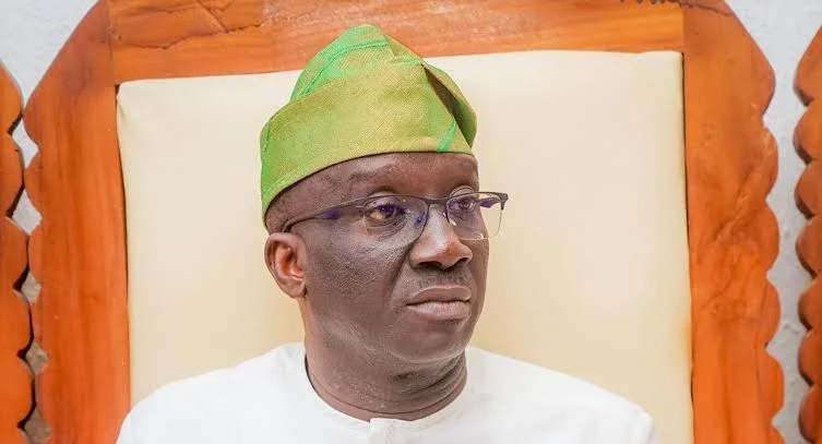 Edo State Governor Monday Okpebholo wearing glasses and a green traditional cap