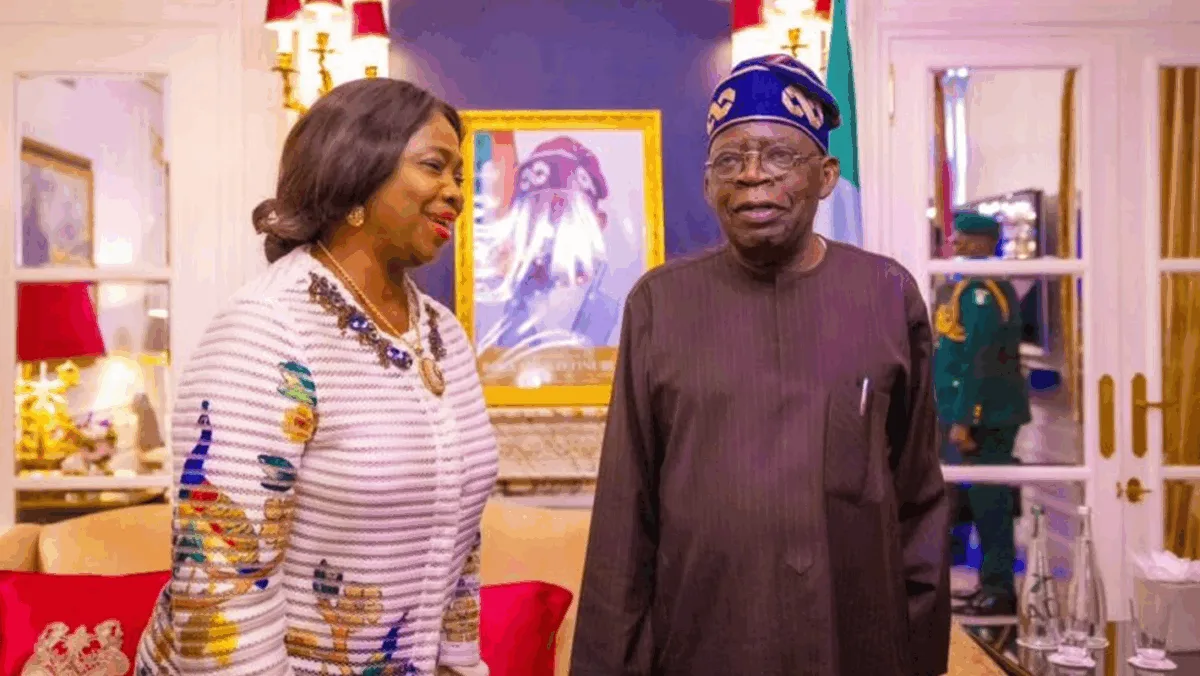 Abike Dabiri-Erewa standing indoors beside President Bola Tinubu