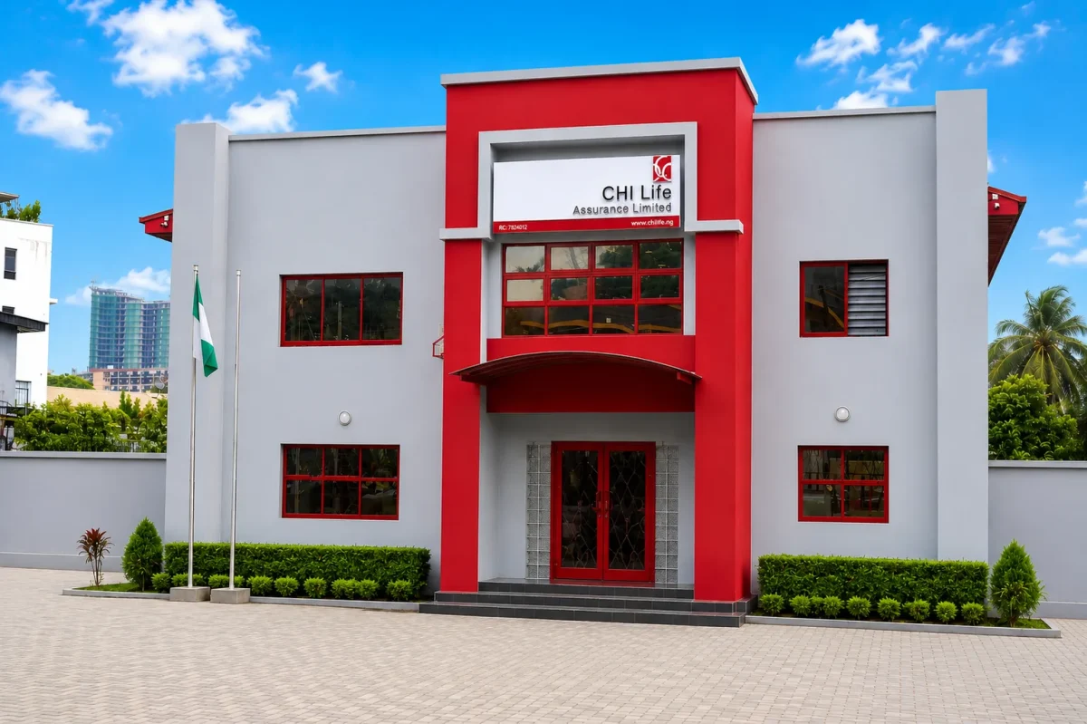Exterior of a CHI Life Assurance Limited building with a red and white facade and a Nigerian flag outside