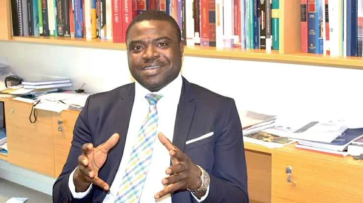Prof. Damilola Olawuyi seated in an office with bookshelves behind him