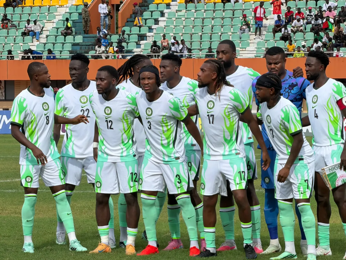 Nigeria Super Eagles players gathered together on a football pitch