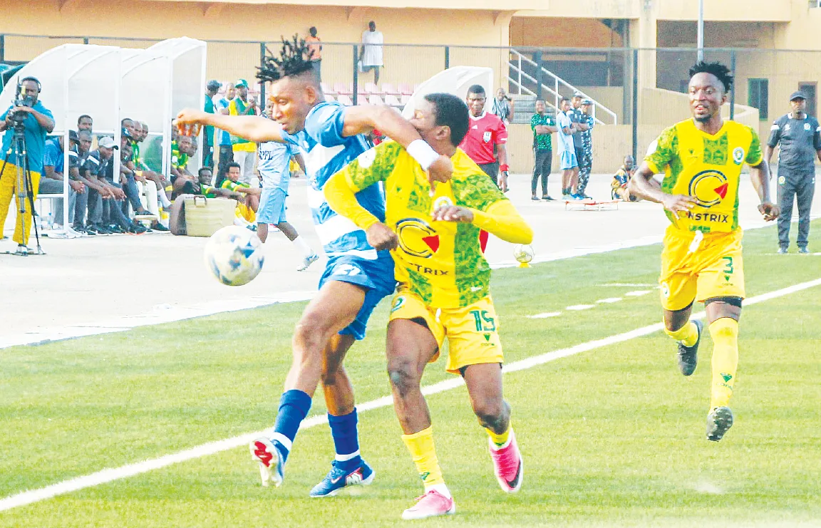 Footballers contesting the ball during a Nigeria Premier Football League match