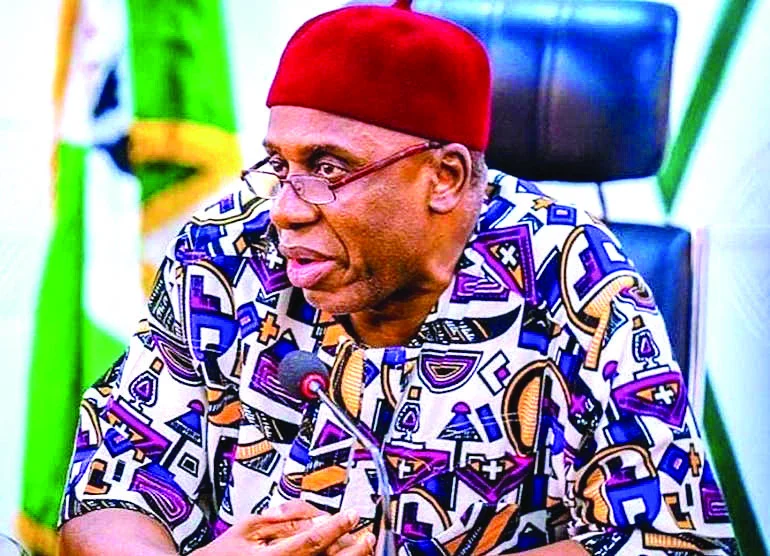 Rotimi Amaechi seated at a microphone during an official engagement