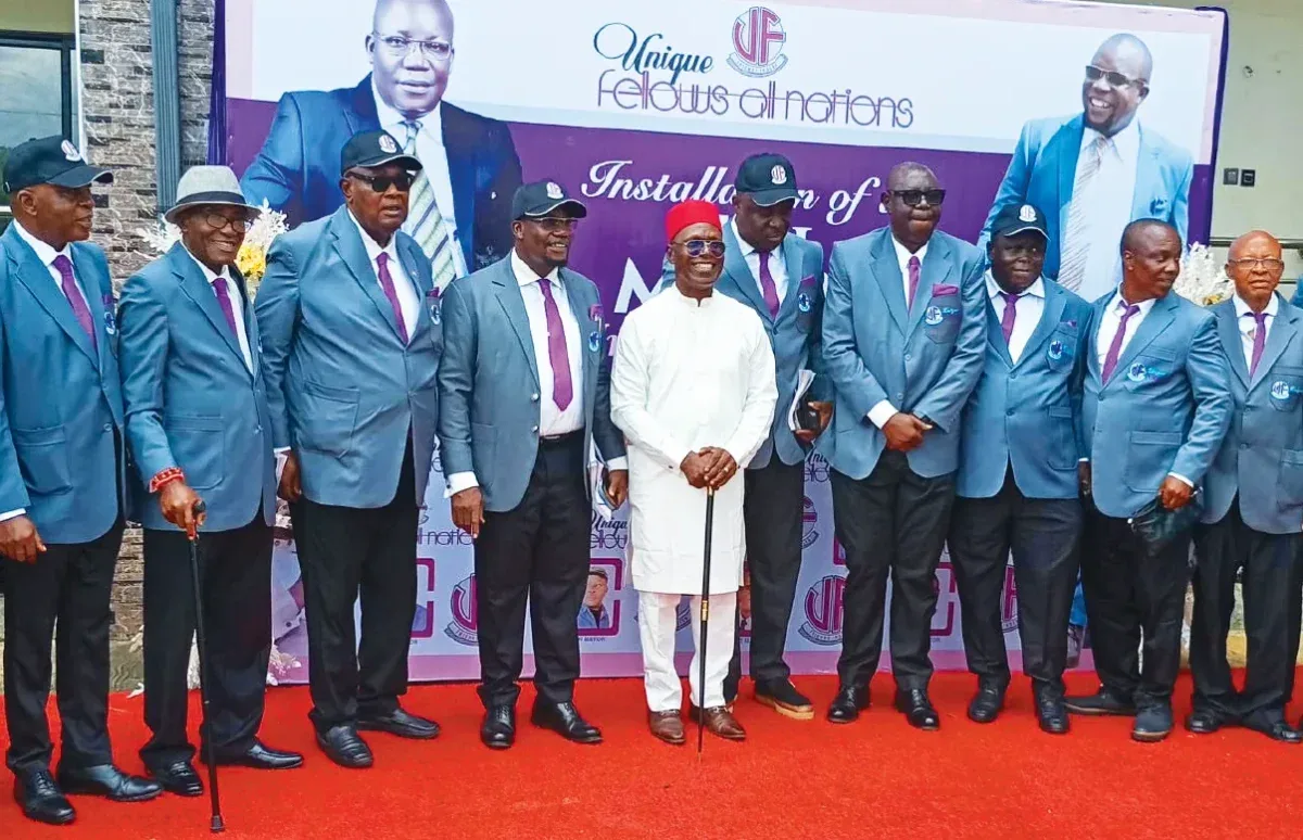Chief Cyril Okoye standing with members of Unique Fellows All Nations Club at an event in Awka