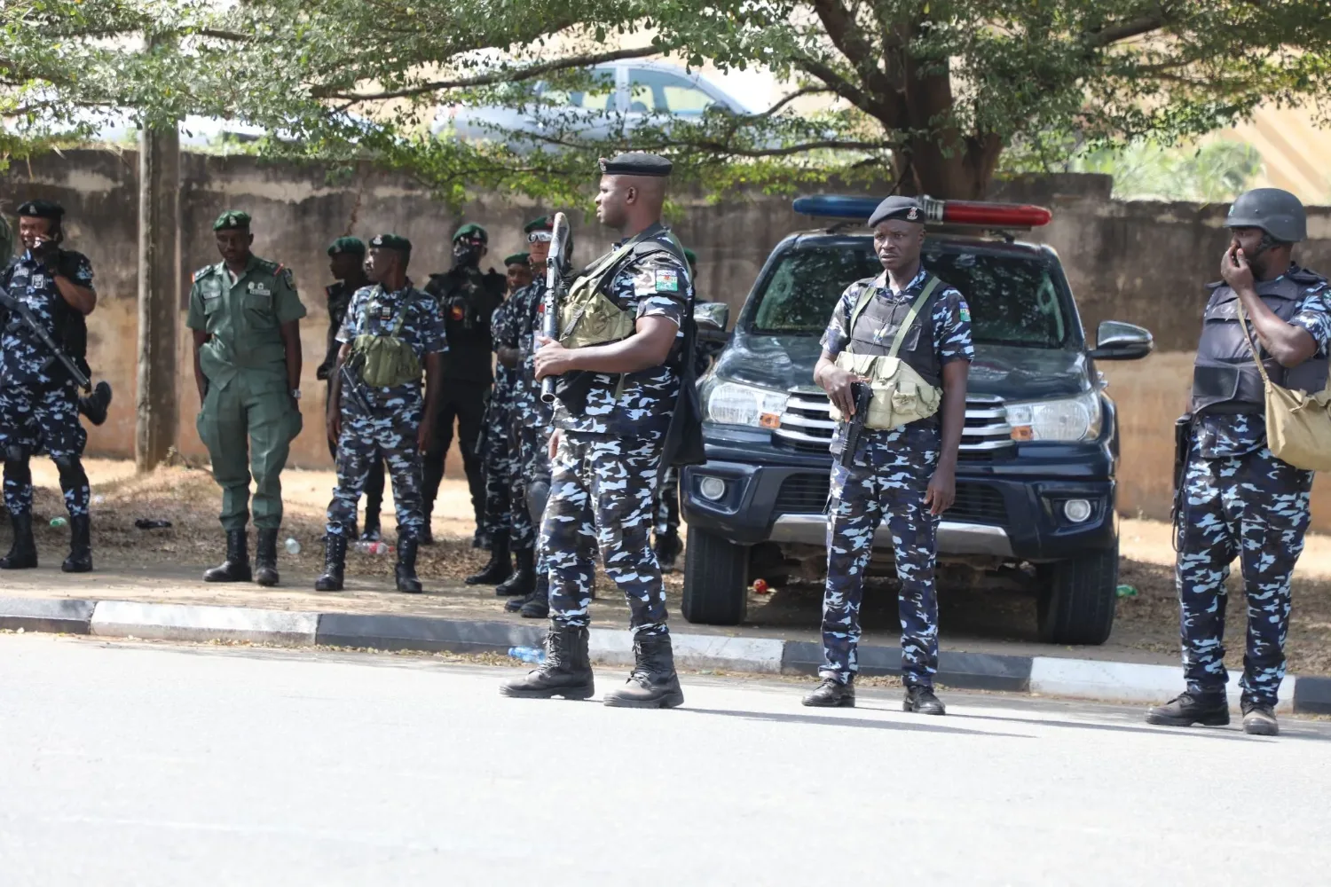 Police officers standing near a patrol vehicle outdoors