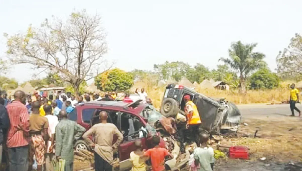 Road crash scene showing a damaged vehicle and people nearby