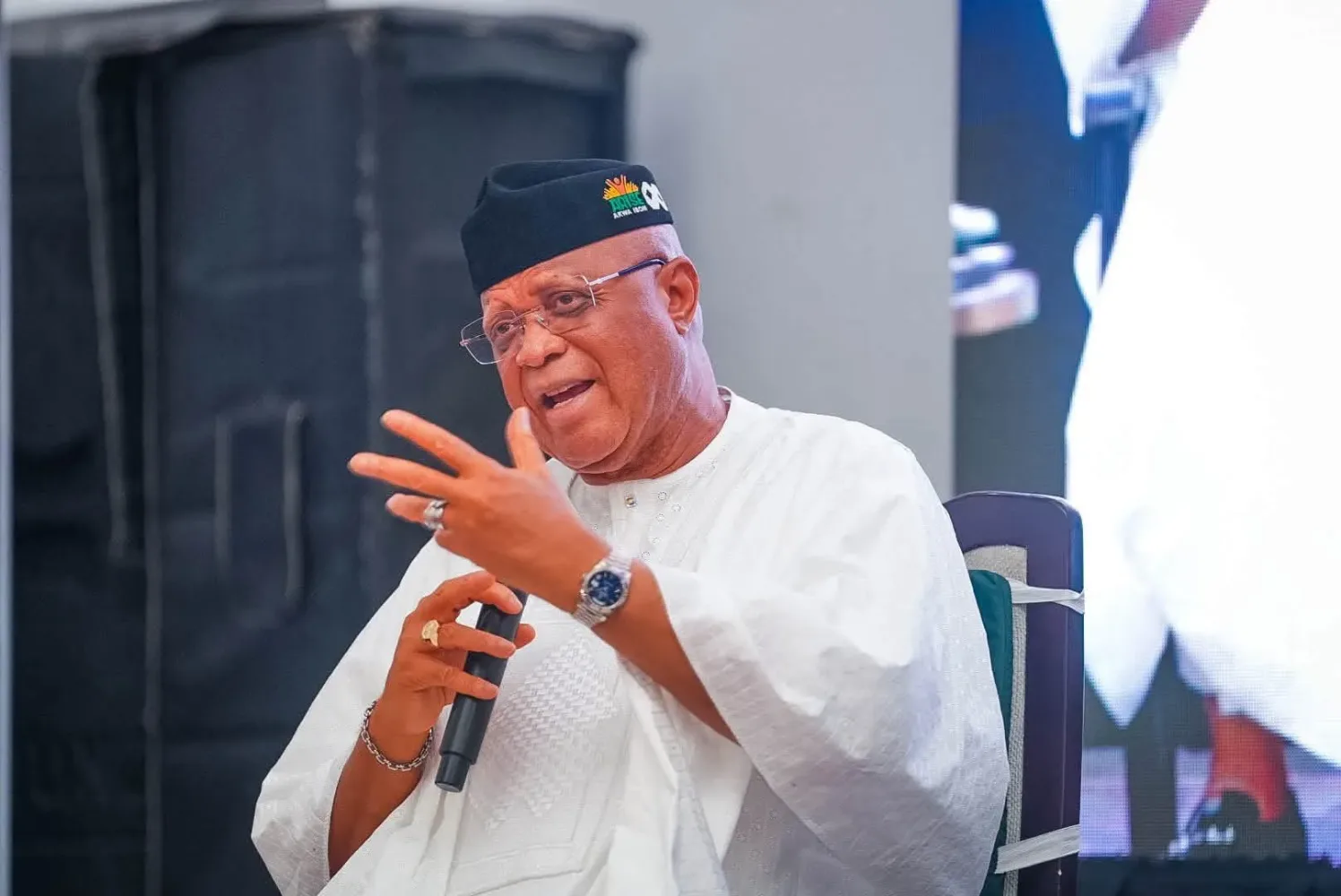 Akwa Ibom State Governor Umo Eno speaking into a microphone while seated