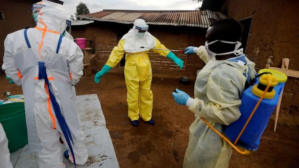 Health workers wearing protective clothing and gloves during an Ebola response activity