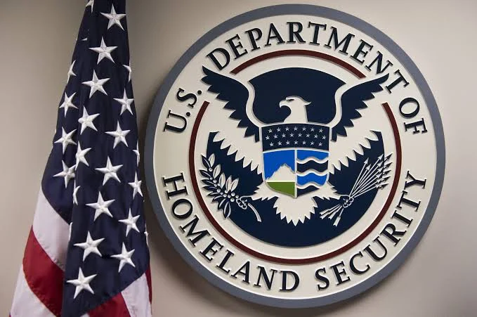 US Department of Homeland Security seal displayed beside an American flag