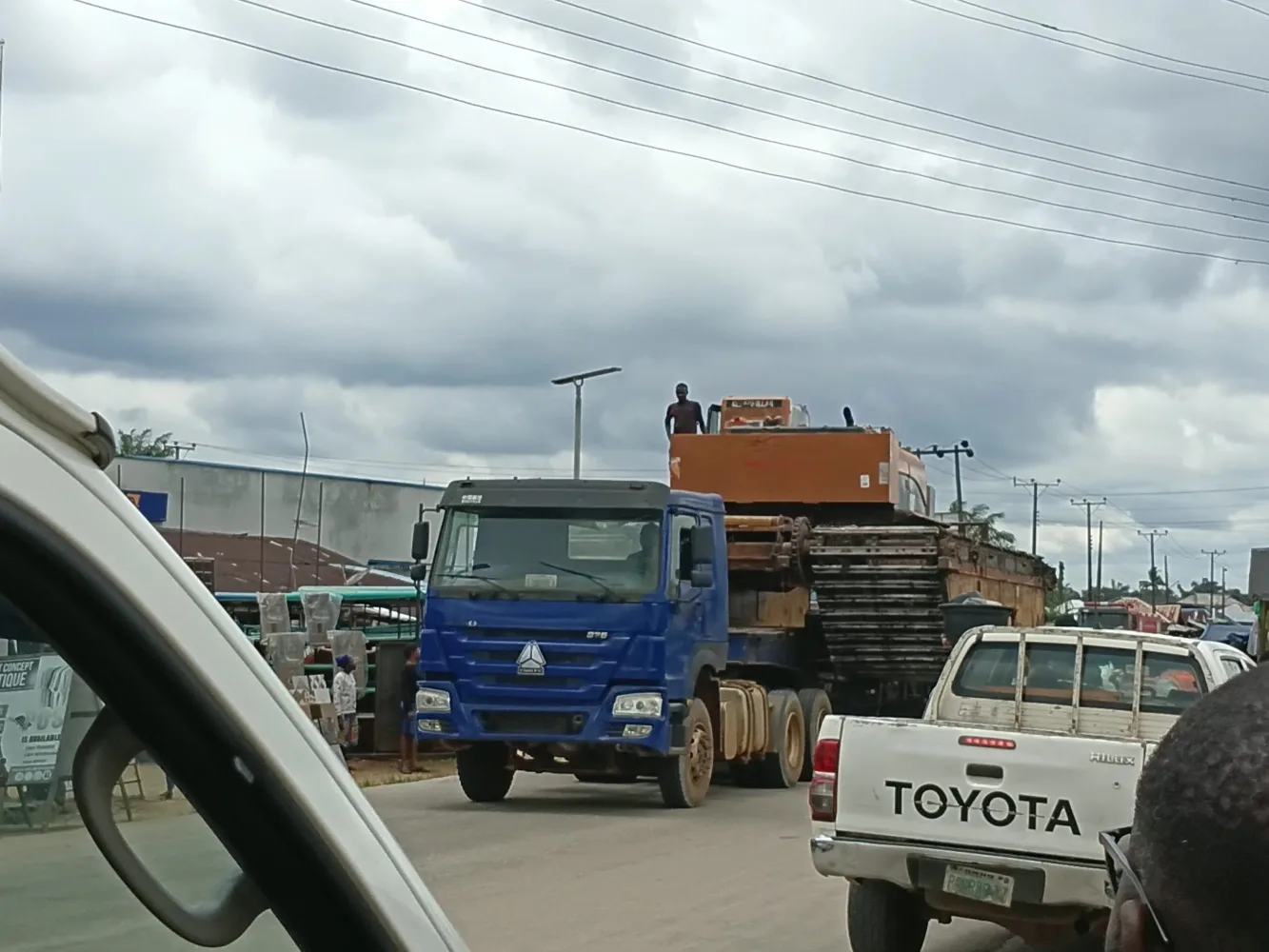 A truck transporting an amphibious excavator for operations in Igbokoda
