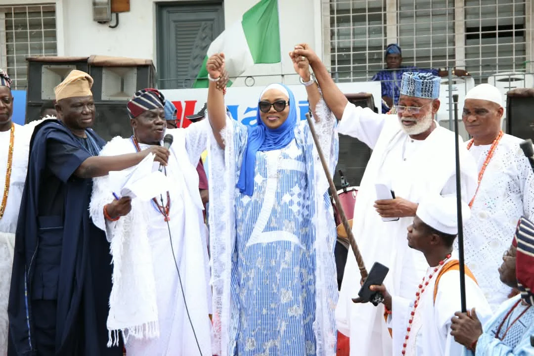 Lateefat Sowunmi-Kolapo standing with community leaders as her hands are raised during an event in Abeokuta